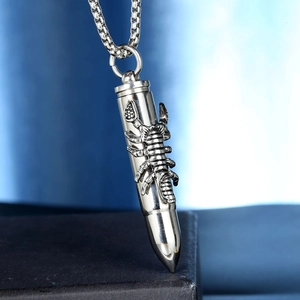 Detailed close-up of stainless steel bullet pendant with 3D embossed scorpion design