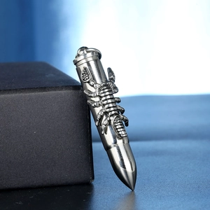 Detailed view of stainless steel bullet pendant with 3D scorpion relief on black gift box