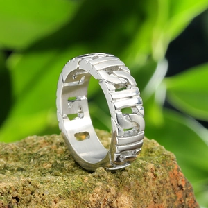 Vintage silver stainless steel chain ring displayed on a natural mossy stone surface