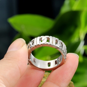Close-up of polished stainless steel Cuban link chain ring for men in silver