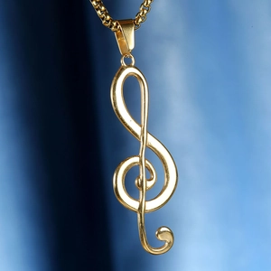 Macro close-up of a polished gold treble clef music note pendant on a sleek box chain