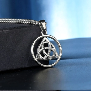 Macro shot of stainless steel triquetra celtic knot pendant on round bead chain necklace