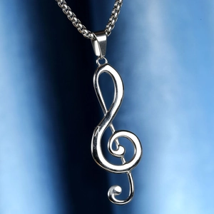 Polished silver treble clef pendant with a stainless steel box chain on a smooth background