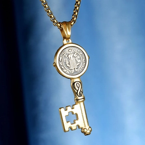 Gold Saint Benedict medal key pendant necklace with hollow cross on blue gradient background