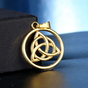 Golden Celtic Triquetra pendant necklace in stainless steel shown on a black jewelry box