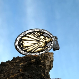 Two-tone Virgin Mary pendant in stainless steel displayed on a natural bark background