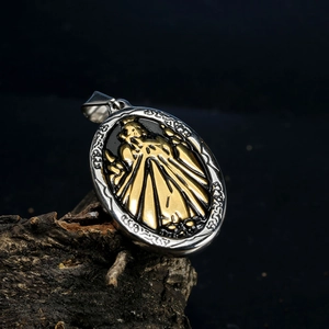 Macro view of a two-tone Virgin Mary oval pendant on dark wood texture background