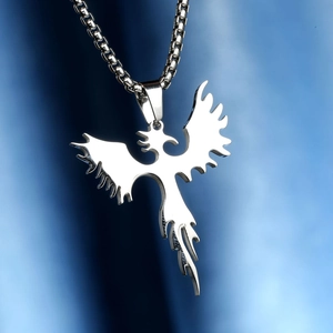 Macro shot of silver phoenix pendant with polished finish on a box chain necklace