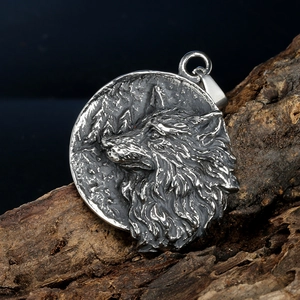 Nordic Viking wolf head round pendant in antique silver steel on natural wood background