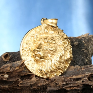Macro detail of high-relief gold lion head pendant with sharp mane textures and wide bail