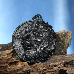 Macro detail of vintage lion head relief pendant on textured wood, dark steel finish
