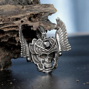 Detail of gothic eagle helmet pendant with black gemstone and antique wing textures