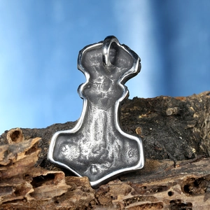 Vintage stainless steel Mjölnir pendant with Thor's hammer design on wood bark