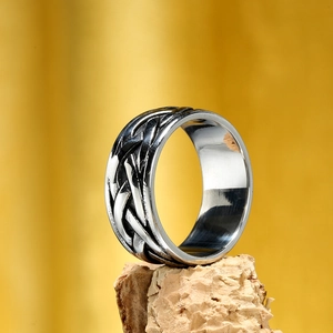 Vintage Viking woven textured ring for men made of durable stainless steel on wood