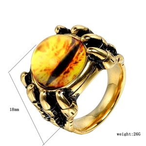Punk style golden dragon claw ring with a yellow eye and stainless steel open band