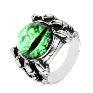 Detail of punk dragon claw ring holding a green evil eye gemstone in vintage steel