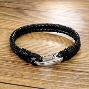 Men's black braided leather bracelet with silver polished metal hook clasp on wood