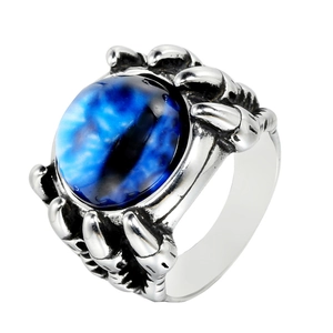 Detail of blue dragon eye stone held by antique silver punk eagle claws on steel ring