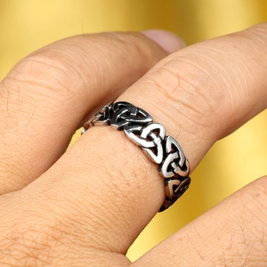 Detailed close-up of a vintage Viking Celtic knot stainless steel ring worn on a finger