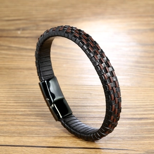 Men's braided leather bracelet with black magnetic stainless steel clasp on wood