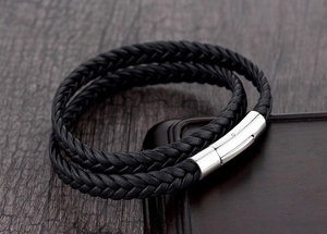 Close-up of black braided leather multi-layer bracelet with polished magnetic clasp