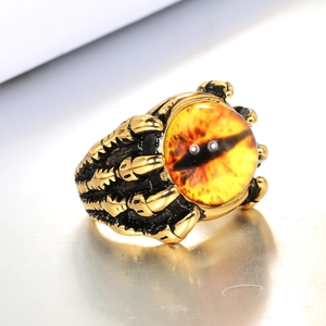 Detailed view of punk dragon claw ring in gold finish with a yellow dragon eye gem