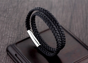 Close-up of men's double-layer black braided leather bracelet with silver magnetic clasp