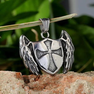 Gothic stainless steel shield pendant with knight cross and wings on a rustic branch