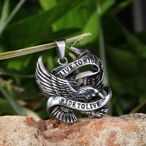 Vintage stainless steel eagle pendant with Live To Ride engraving on wood branch