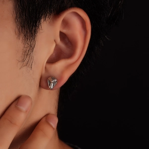 Detailed close-up of a silver snake head stud earring with realistic scale textures