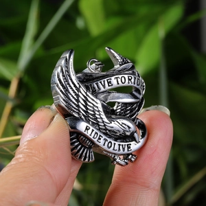 Detailed shot of retro eagle pendant featuring Live to Ride Ride to Live engraved ribbons