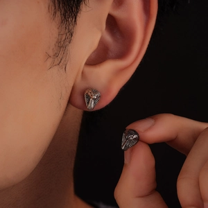 Retro snake head magnetic earrings with detailed silver scales and punk aesthetic