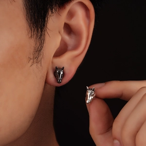 Minimalist horse head stud earrings in silver and black metal with 3D sculpted textures