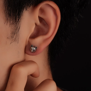 Close-up of retro silver wolf head earring with detailed fur texture on ear