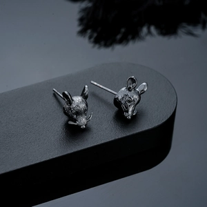 Detailed view of dark grey zodiac rat studs with intricate fur texture carving