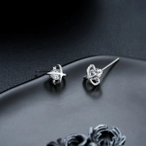 Crossed star orbital stud earrings in silver with brilliant round cut cubic zirconia