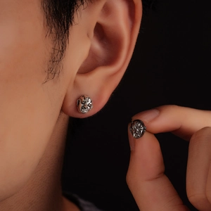 Retro silver mask earrings with vintage metal texture and intricate drama mask design