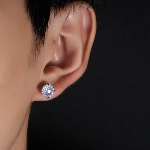 Macro close-up of a gradient cut stud earring with four-claw setting on ear