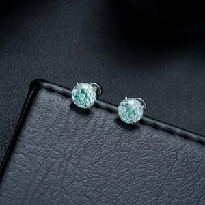Macro shot of light blue gradient zirconia earrings with a four-prong stainless steel setting
