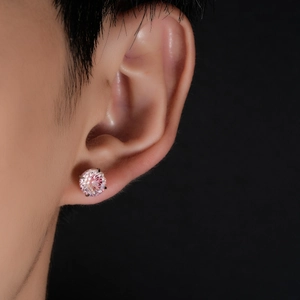 Close-up of four-prong pink gradient crystal stud earring worn on a model's ear
