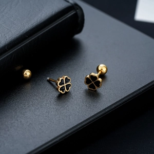 Detail of clover stud earrings with black enamel inlay and screw ball back closure