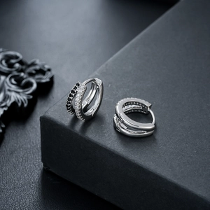 Detailed close-up of double-layer earrings with black and white pavé cubic zirconia
