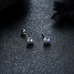 Macro shot of four-claw stainless steel earrings with gradient firework cut stones