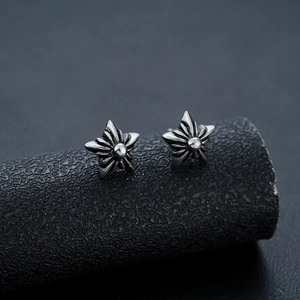 Close-up of gothic pentagram stud earring with an oxidized vintage silver finish