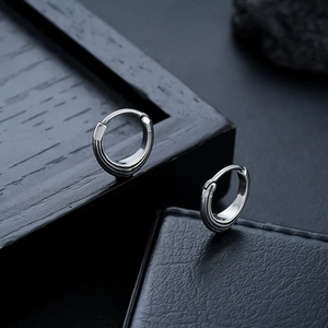 Polished silver triangle earrings featuring a classic round hoop clasp and metallic luster