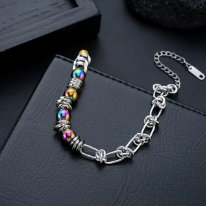 Détail du bracelet en perles irisées avec maillons de chaîne épais en acier inoxydable poli