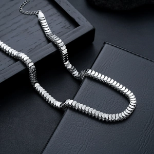 Detail of fish scale titanium steel necklace with polished D-shaped links and lobster clasp