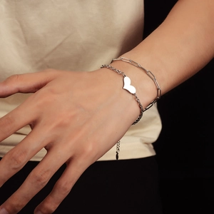 Double-layered stainless steel heart bracelet featuring a minimalist paperclip chain style