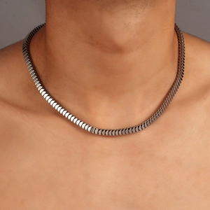 Close-up of polished silver scale chain necklace with smooth mirror finish for men