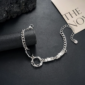 Macro view of S925 silver Cuban chain with textured metal rings and black zircon inlay